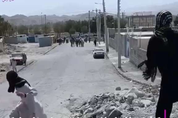 A protester throwing stones at security forces in the city of Rask in Sistan-Baluchsetan province on June 23, 2023