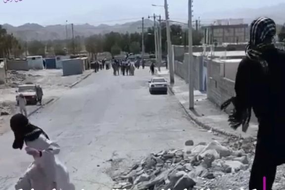 A protester throwing stones at security forces in the city of Rask in Sistan-Baluchsetan province on June 23, 2023