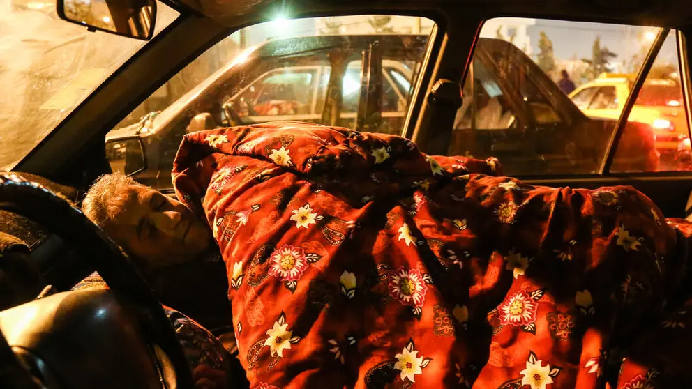 A car-sleeping driver in Tehran