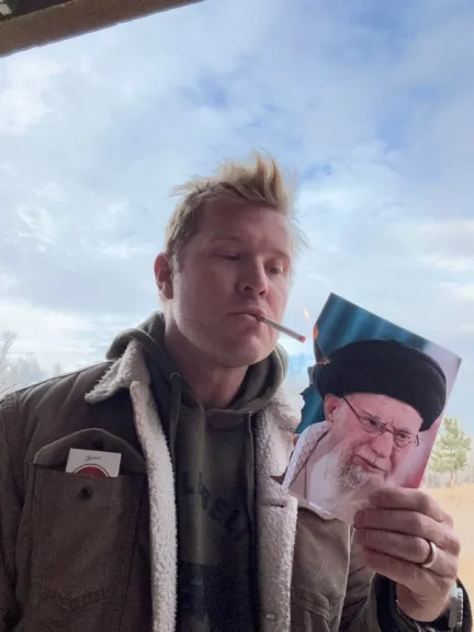 US senator posts photo lighting cigarette with burning image of Iran leader