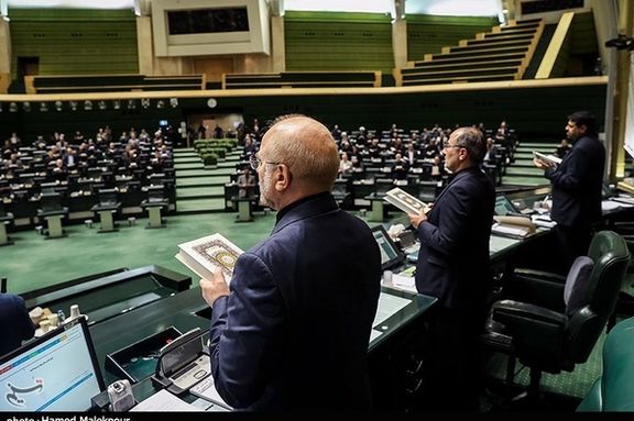Iran’s Parliament Speaker Mohammad Bagher Ghalibaf (left) holding a copy of the Quran in a symbolic move to condemn the burning of Islam’s holy book during a parliament session in July 2023