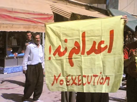Protesters in Iran hold a banner that reads 'No Execution!' in both Persian and English, voicing their opposition to the country's use of the death penalty.