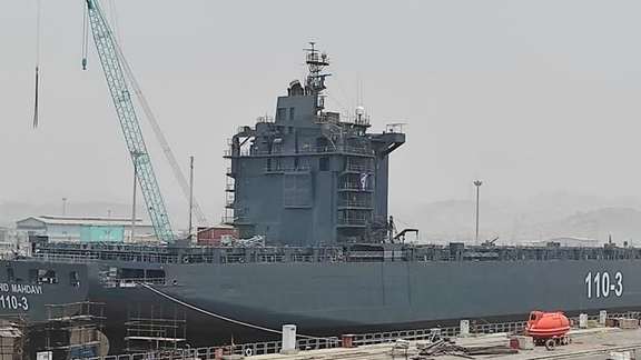 An Iranian ship being transformed into a navy vessel in a Persian Gulf port