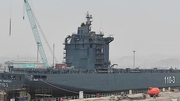 An Iranian ship being transformed into a navy vessel in a Persian Gulf port