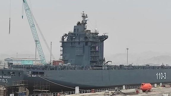 An Iranian ship being transformed into a navy vessel in a Persian Gulf port