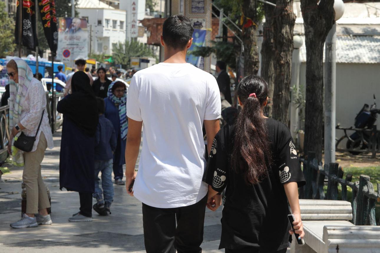 People walk along a street in Tehran. Health officials say sexual transmission is the leading recorded route for new HIV cases in Iran.