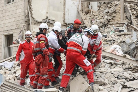 Rescue workers from the Iranian Red Crescent carry an elderly woman from the rubble of a damaged building in Tehran, amid US-Israeli conflict with Iran, March 16, 2026