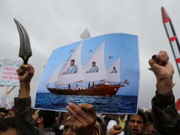 A protester holds a poster during a rally by Houthi supporters to show support to Palestinians in the Gaza Strip, in Sanaa, Yemen April 26, 2024.