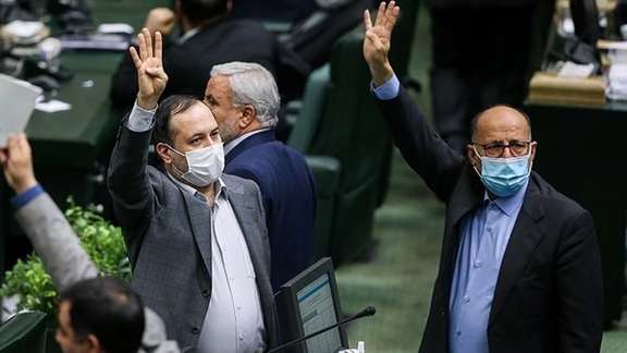 Lawmakers raising their hands in parliament session on Sunday.
