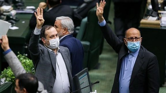 Lawmakers raising their hands in parliament session on Sunday.
