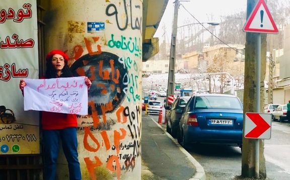 مریم یحیوی پس از آزادی پارچهنوشته «نه به اعدام» را مقابل زندان اوین در دست گرفت