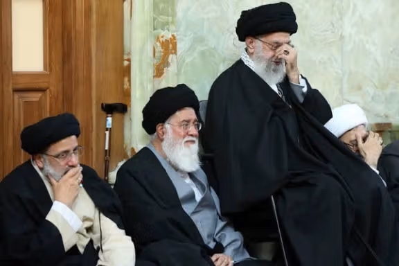 Ahmad Alamolhoda (center) with Iran’s ruler Ali Khamenei (right) and President Ebrahim Raisi in a ceremony