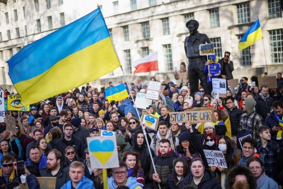 People hold banners and flags during an anti-war protest, after Russia invaded Ukraine, in London. February 26, 2022.