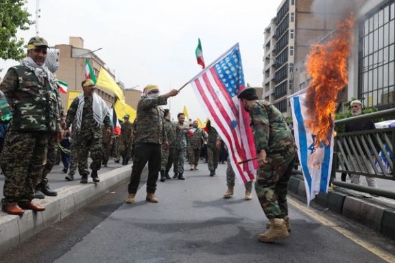Military men setting fire o Israeli and US flags. April 29, 2022