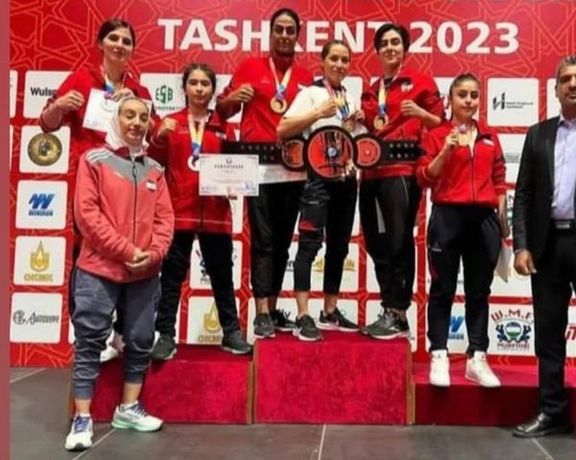 Iran's national women's muay thai team standing on podium without mandatory hijab at the Asian Championships held in Tashkent, Uzbekistan's capital