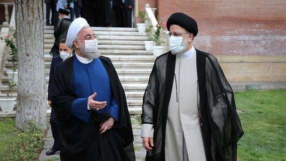 Former president Hassan Rouhani and President Ebrahim Raisi in August 2021