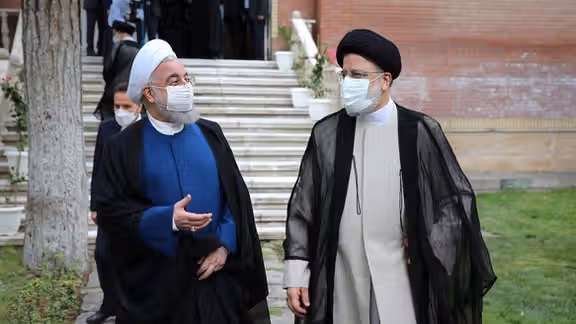 Iran former president Hassan Rouhani with Ebrahim Raisi on inauguration day.