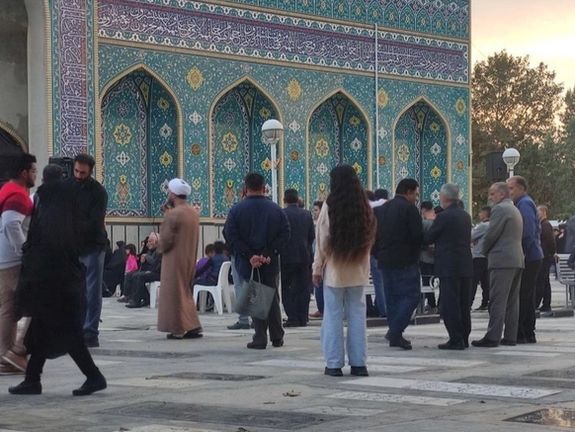 An Iranian woman unveiling in public