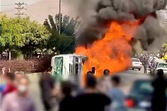 Protesters set fire to a police car in Karaj on November 3