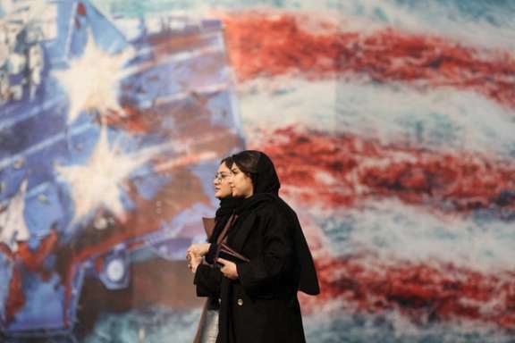 People walk past an anti-US billboard in Tehran, Iran, January 26, 2026