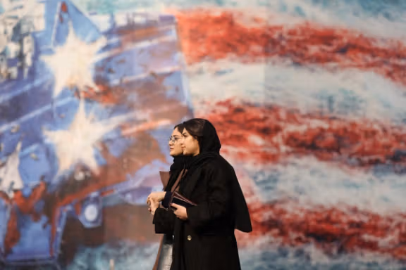 People walk past an anti-US billboard in Tehran, Iran, January 26, 2026