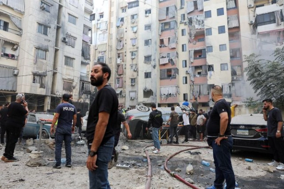 People inspect the site of an Israeli strike in the southern suburbs of Beirut, Lebanon, September 20, 2024.