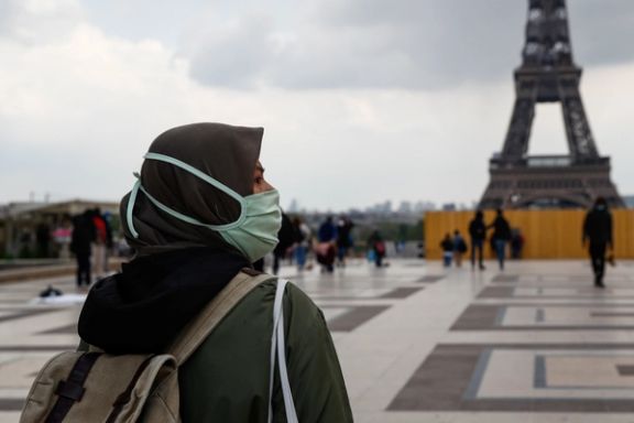 A woman, wearing a hijab and a protective face mask, walks at Trocadero square near the Eiffel Tower in Paris, France, May 2, 2021.