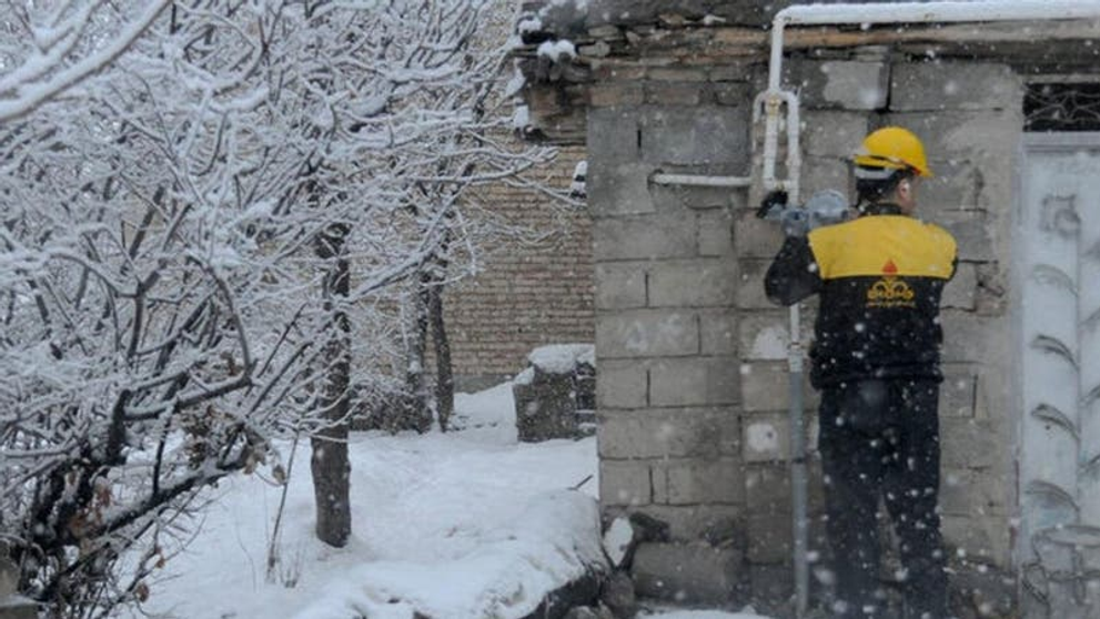 An Iranian gas technician working in freezing conditions as the country grapples with energy shortages.