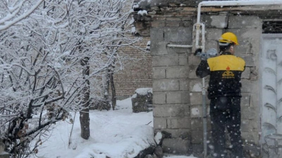 An Iranian gas technician working in freezing conditions as the country grapples with energy shortages.