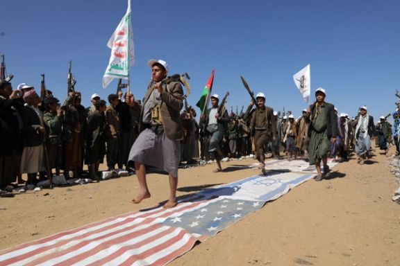 Tribesmen loyal to the Houthis march on U.S. and Israeli flags during a military parade for new tribal recruits amid escalating tensions in the Red Sea. Jan. 22,2024