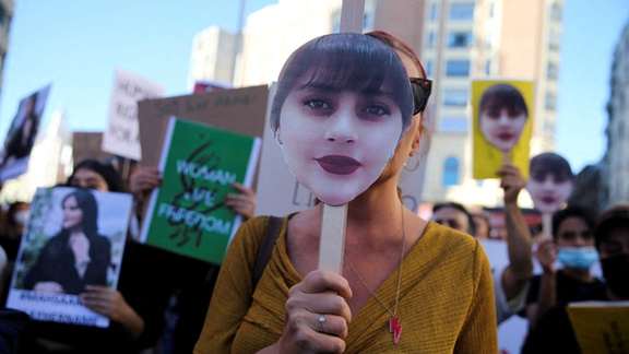 Protesters holding images of Mahsa Amini in a protest in Madrid, Spain on October 1, 2022