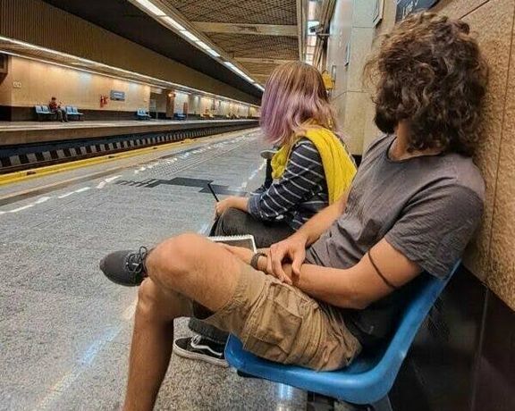 A man and woman at a subway station in Tehran