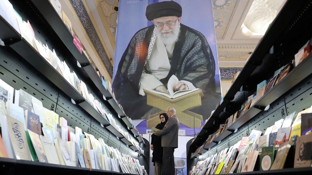 People look at books during the International Book Fair in Tehran, Iran, May 13, 2024.