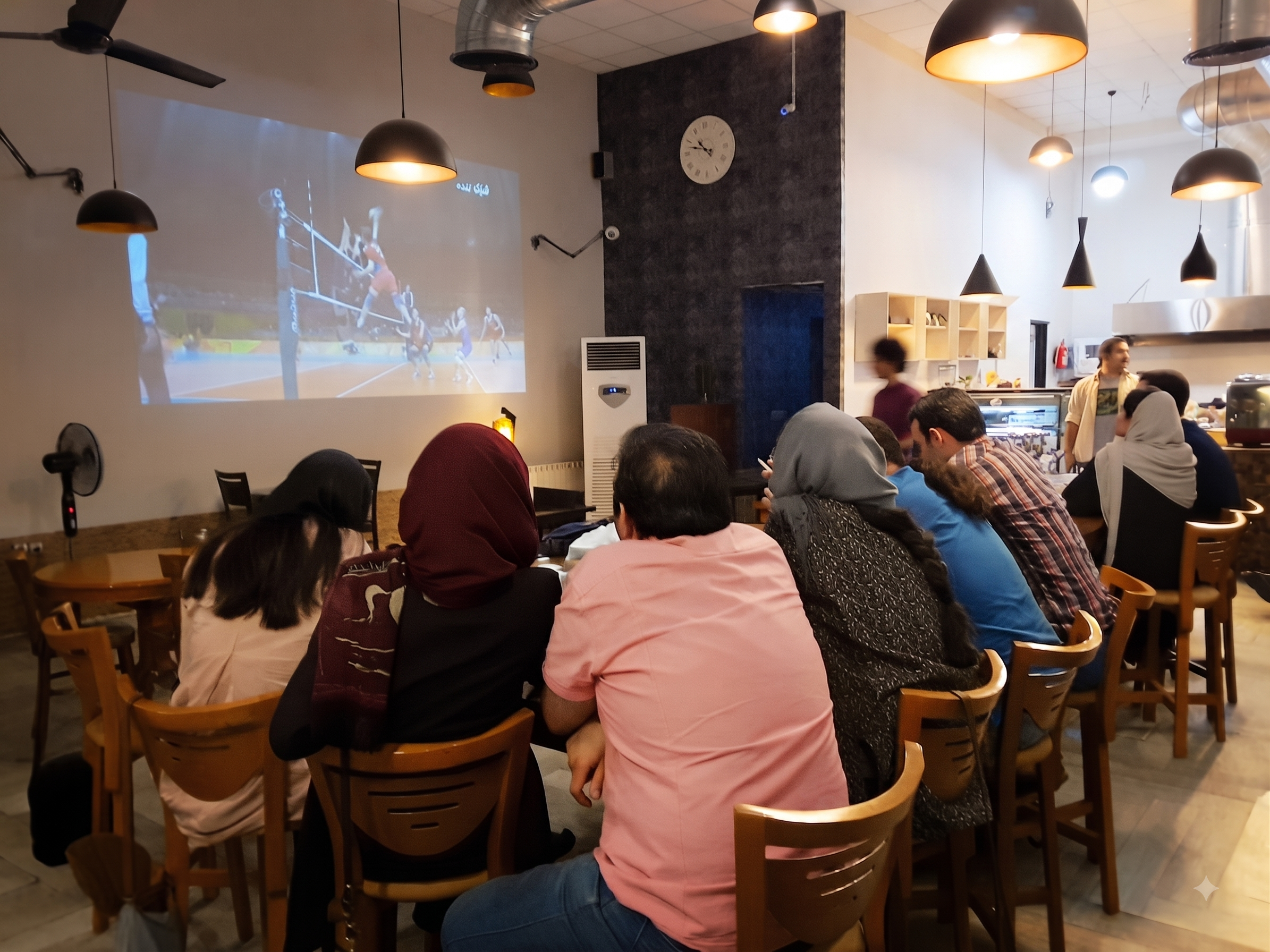 Friends gathered at a cafe in Tehran to watch a match together.
