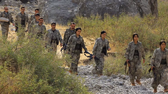 Fighters with the Kurdistan Workers' Party (PKK) walk for a disarmament ceremony marking a significant step toward ending the decades-long conflict between Turkey and the outlawed group, in the Qandil mountains, Iraq October 26, 2025.