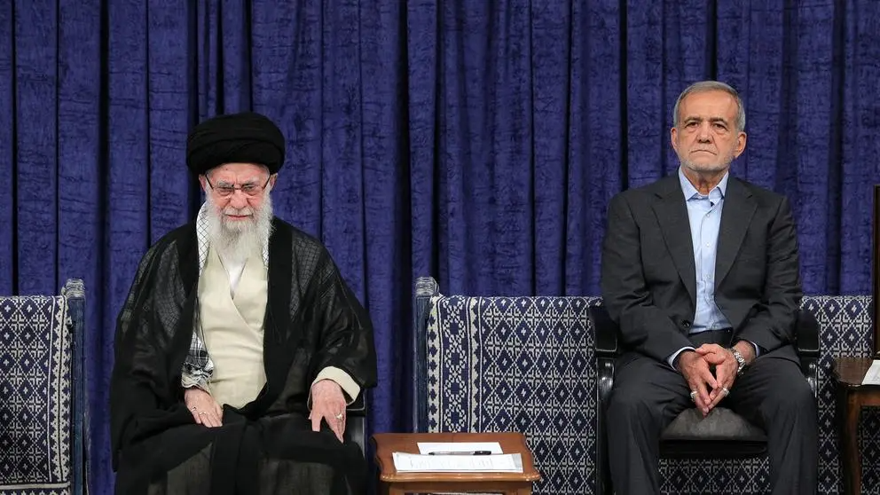 President Masoud Pezeshkian (right) sitting next to Supreme Leader Ali Khamenei (left) during a ceremony in Tehran.