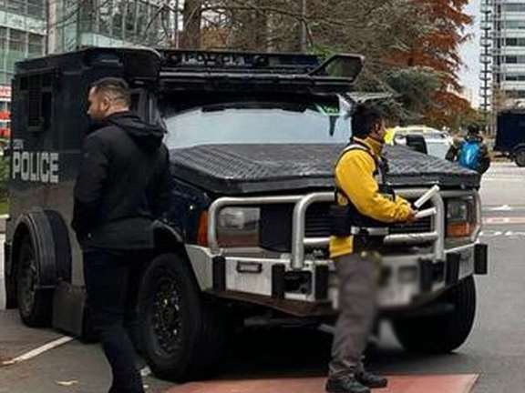 Armored police vehicles are seen outside the headquarters of Iran International on Nov. 19, 2022