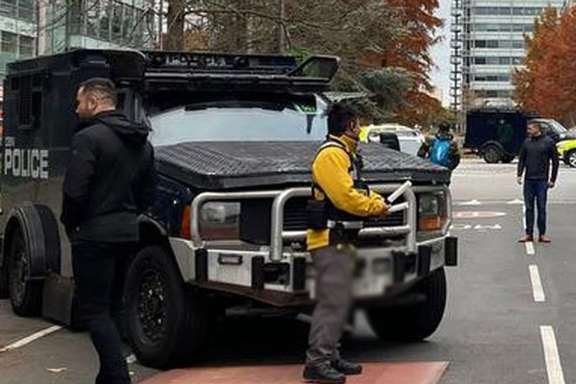 Armored police vehicles are seen outside the headquarters of Iran International on Nov. 19, 2022