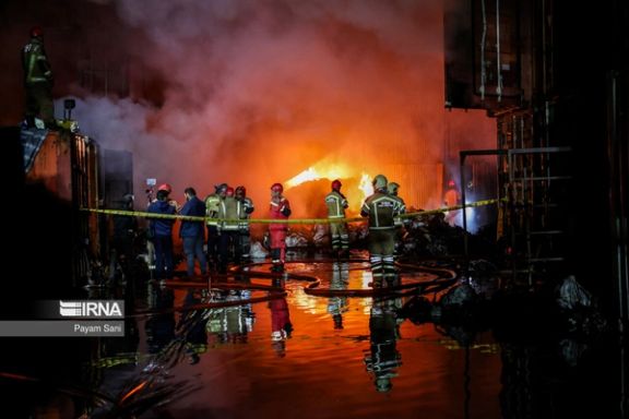 Firefighters work at the scene of a large fire in a warehouse complex in southern Tehran, April 25, 2024