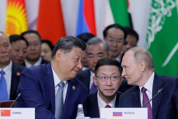 Russian President Vladimir Putin and Chinese President Xi Jinping speak during a plenary session in the outreach/BRICS Plus format at the BRICS summit in Kazan, Russia October 24, 2024.