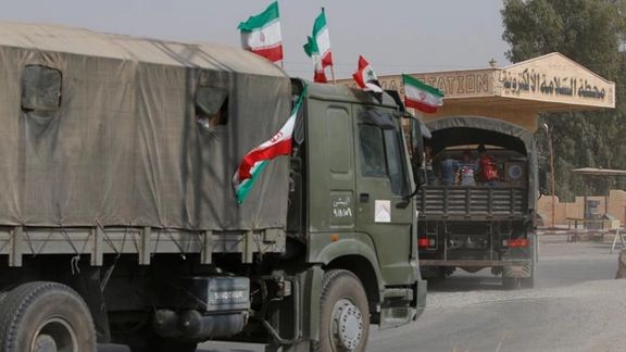 Iranian and Syrian flags flutter on a truck in Deir ez-Zor, Syria.