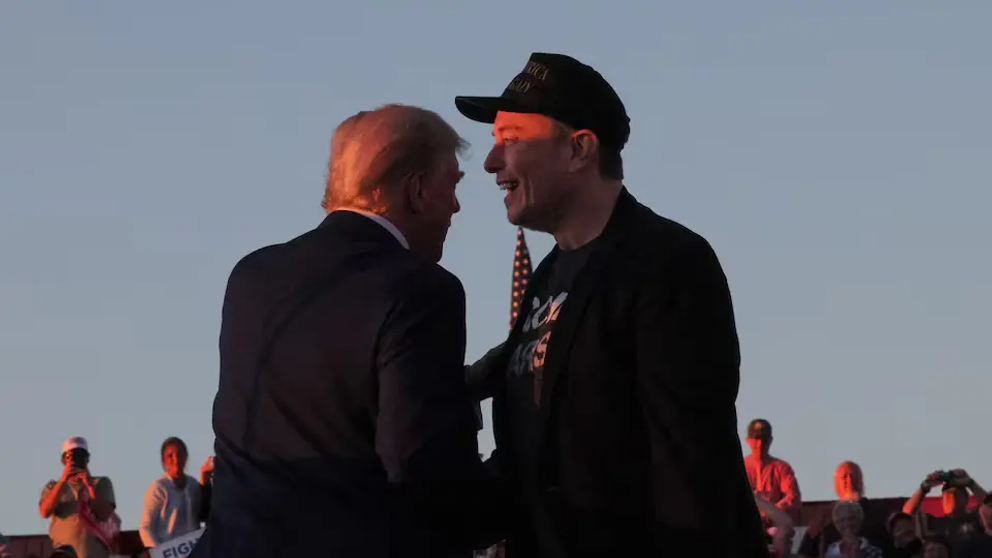 Tesla CEO and X owner Elon Musk stands with Republican presidential nominee former US president Donald Trump during a campaign rally, on the day Trump returns to the site of the July assassination attempt against him, in Butler, Pennsylvania, US, October 5, 2024.