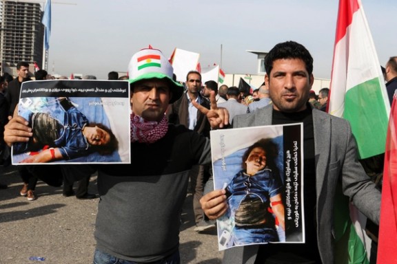 People hold placards during a demonstration in front of the United Nations headquarters, following missile attacks by Iran's Revolutionary Guards, in Erbil, Iraq, January 16, 2024.