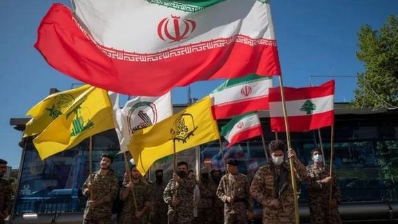 Flags of the Islamic Republic of Iran and its armed allies like Hezbollah next to the Lebanese flag