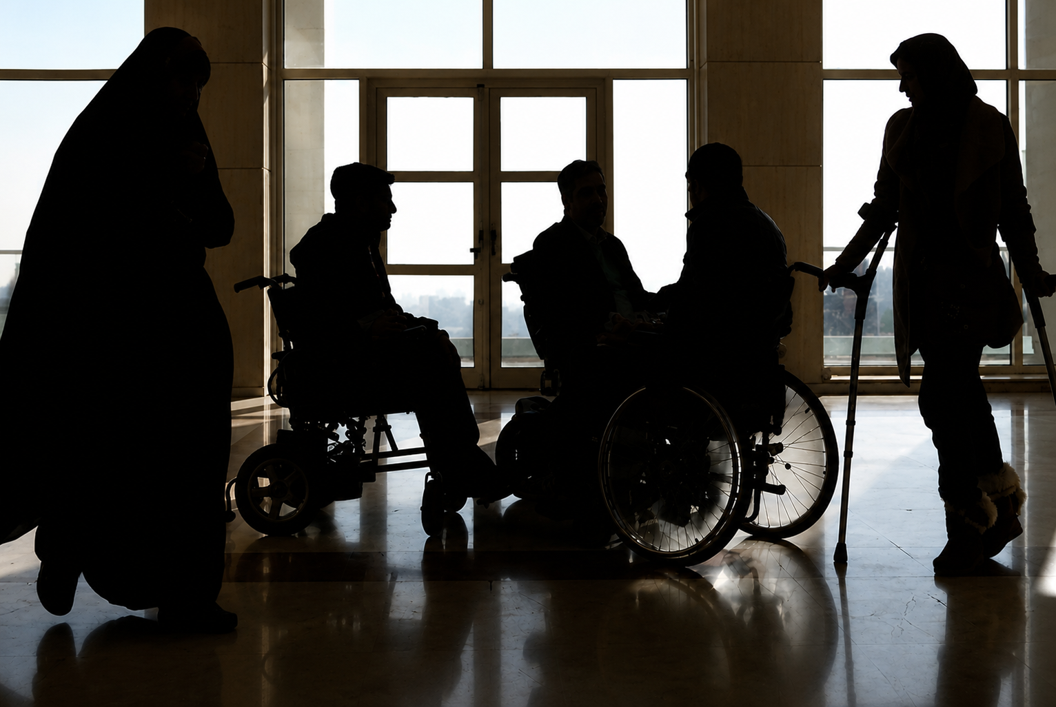 Silhouettes of people with disabilities gather inside a public building in Iran.