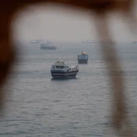 Iran officials threaten Hormuz escalation as Trump says deal is near