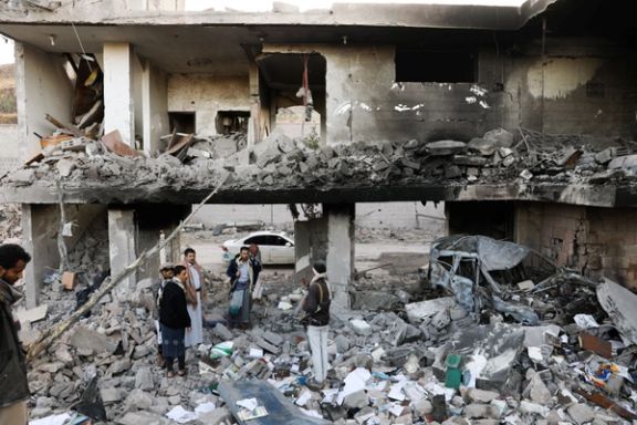 Guards stand on the rubble of a house hit by Saudi-led air strikes in Sanaa Guards stand on the rubble of a house hit by Saudi-led air strikes in Sanaa, Yemen, January 18, 2022.