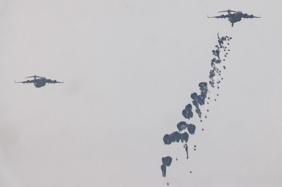 Humanitarian aid falls through the sky towards the Gaza Strip after being dropped from an aircraft, amid the ongoing conflict between Israel and the Palestinian Islamist group Hamas, as seen from Israel, March 29, 2024.