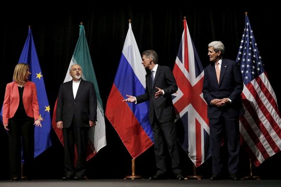 British Foreign Secretary Philip Hammond (2nd R), US Secretary of State John Kerry (R) and European Union High Representative for Foreign Affairs Federica Mogherini (L) talk to Iranian Foreign Minister Mohammad Javad Zarif as the wait for Russian Foreign Minister Sergey Lavrov (not pictured) for a group picture, Vienna, Austria July 14, 2015
