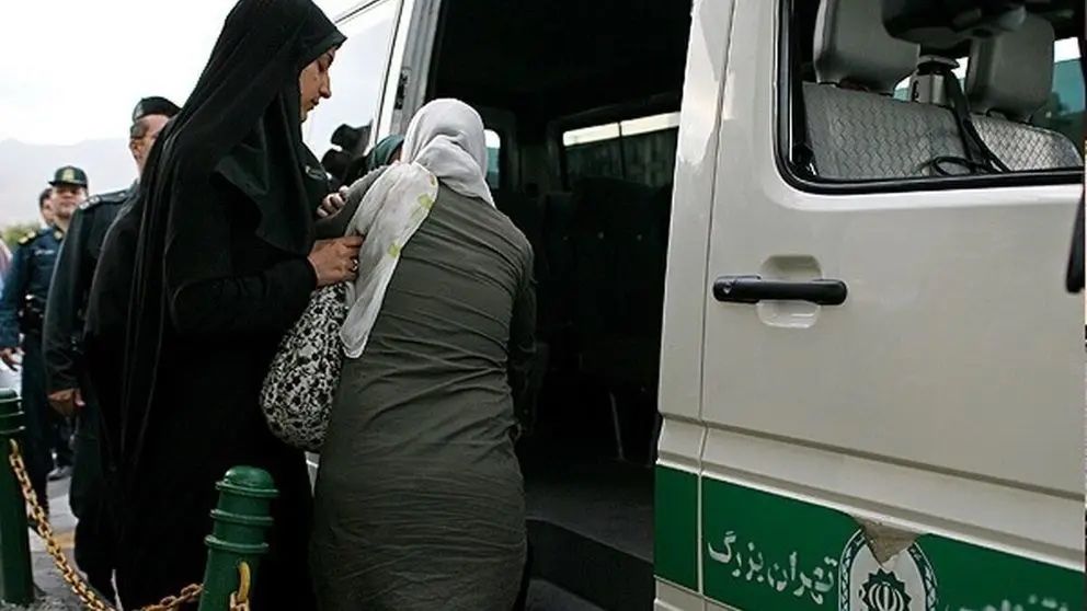 Hijab patrol officers dragging a woman in their van